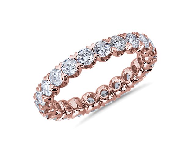 Brilliant diamonds endlessly encircle this stunning eternity ring crafted from 14k white gold. The V-prong pavé settings highlight the stones in elegantly contemporary style.