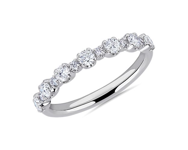 Let your love shine with this anniversary band set with round-cut diamonds alternating in size along the front of the band. It is crafted from luxurious 14k white gold that promises an enduring cool lustre.
