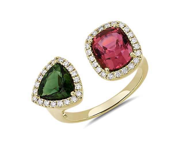 This beautiful two stone ring features a cushion cut pink tourmaline and a trillion cut green tourmaline stone surrounded by a sparkling halo of diamonds.  Crafted in 18k yellow gold, this ring is the perfect statement piece.