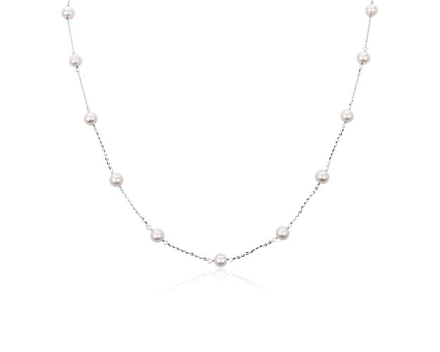 Lustrous freshwater pearls gleam in increments along this gracefully draping 36-inch long necklace. It is crafted from sterling silver, which complements the pearls with a cool gleam.