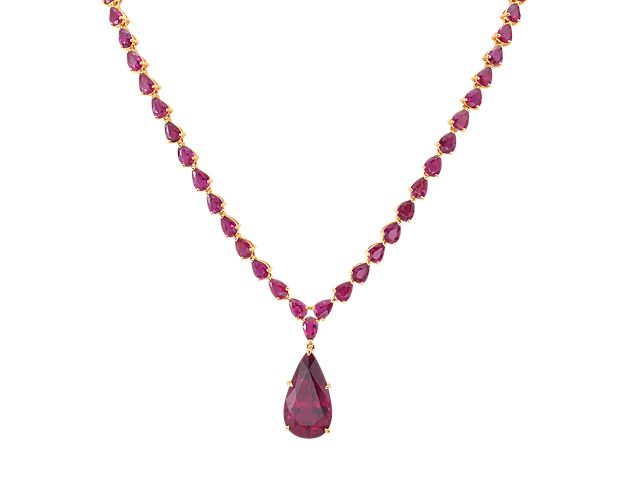 Make a statement with this stunning ruby and rubellite tourmaline necklace.  Set in luxurious 18k yellow gold, this necklace features a pear-shaped rubellite tourmaline that cascades down from a necklace lined entirely with pear-shaped rubies.  This necklace simply cannot be ignored.