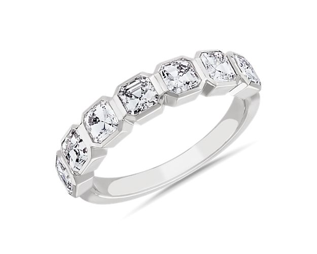 Mesmerize the eye with this stunning anniversary band featuring seven Asscher-cut diamonds that bring vintage-inspired art-deco charm. The beautiful bevel setting is crafted from 14k white gold that promises a romantic bright gleam.