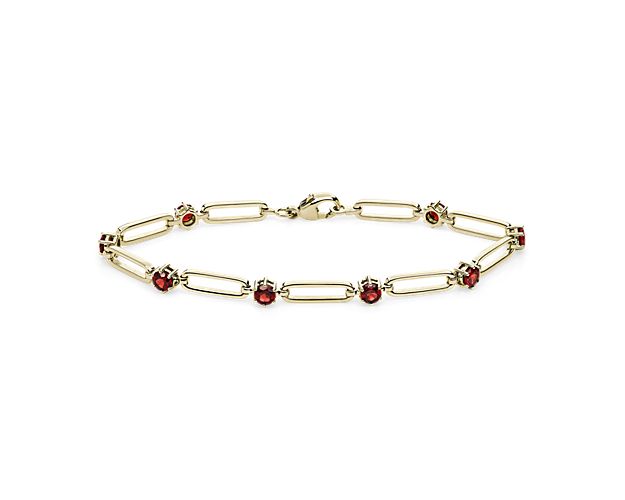Go for casually luxurious style with this elegant paper clip bracelet featuring gleaming 14k yellow gold design. Between each paper clip link nestles a passionate red garnet stone, adding a touch of bold color to your wrist.
