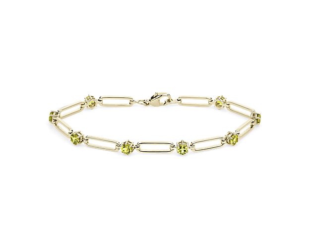 Opt for simple elegance when you wear this paper clip bracelet beautifully crafted from gleaming 14k yellow gold. A brightly gleaming peridot stone nestles between each link, adding eye-catching sparkle and color.
