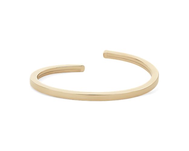 Crafted in 14k yellow gold, this flexible cuff makes it easy to wear with any outfit.  Flat sides add a modern edge to this classic piece.