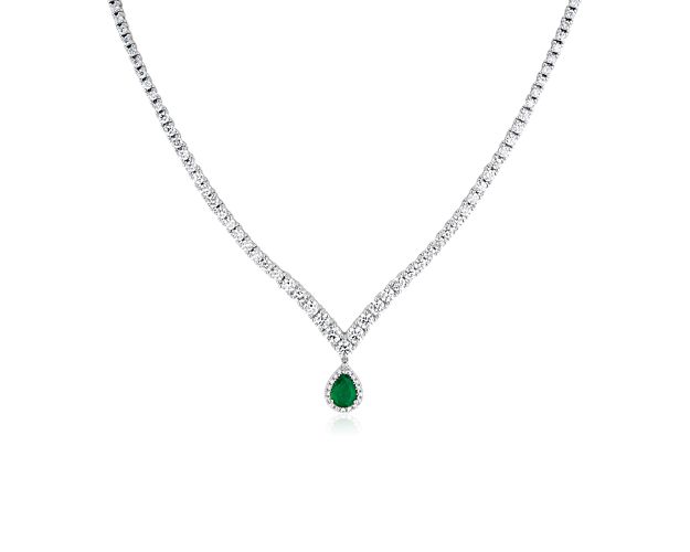 A pear-cut emerald dangles from the point of this gracefully shaped chevron necklace, adding elegant allure. The 14k white gold design is set with stunning diamonds that give it dramatic sparkle as you catch the light.