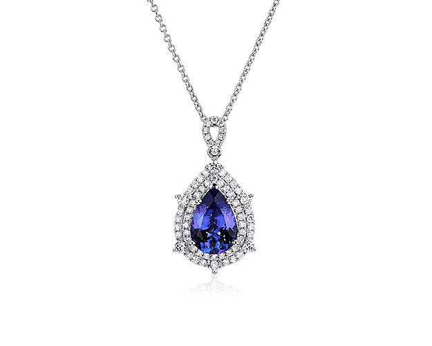 Steal their attention with this stunning pendant featuring a pear-cut blue tanzanite stone sparkling at its heart. A brilliant double halo of diamonds adds dramatic sparkle to the intricate 14k white gold design.