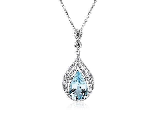 Instantly elevate your style with this stunning pendant featuring a gorgeous pear-cut light blue aquamarine surrounded by a graceful tiered double diamond halo. The 14k white gold complements the cool tones of the stone with its soft gleam.