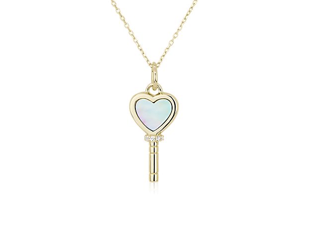 Heart-shaped mother of pearl gold pendant in a watch key shape.