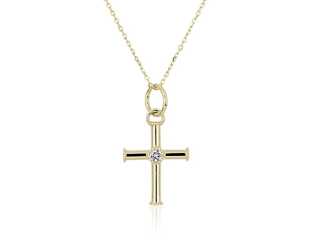 Express your faith with this elegant 18k yellow gold cross charm featuring a white topaz stone gleaming at the centre. Delicate milgrain detail accents the arm ends and forms an antique-inspired bezel around the stone.