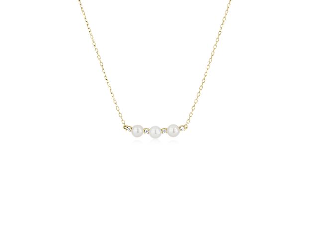Three pearls gleam along this bar necklace crafted from warmly lustrous 14k yellow gold. Between each pearl, a petite spacer diamond adds a touch of sparkle.