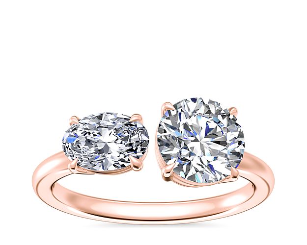 Featuring lustruos 14k rose gold design, this two-stone engagement ring promises a look of exceptional romance. It features an oval-cut east-west set diamond shimmering brilliantly next to your chosen round, princess, pear, asscher, emerald-cut, radiant, cushion, marquise, or oval stone.