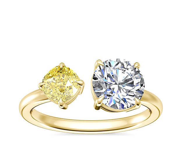 A brilliant fancy yellow cushion-cut diamond shimmers in symphony with a round, princess, pear, asscher, emerald-cut, radiant, cushion, marquise, heart, or oval stone in this eye-catching two-stone engagement ring. The warm luster of the 14k yellow gold design beautifully complements the stones.