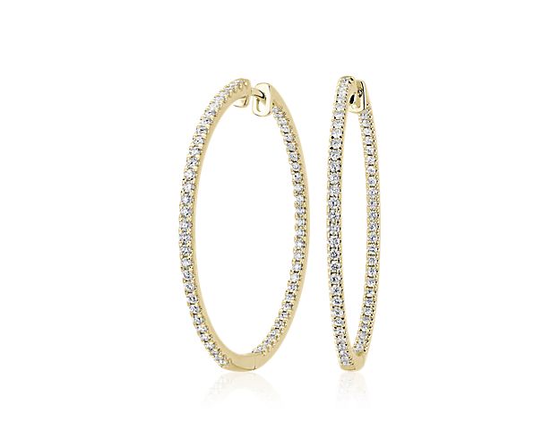 Elevate your look with these slender hoop earrings featuring warmly lustrous 14k yellow gold design. The front-facing edges are set with brilliant diamonds that catch the light as you move.