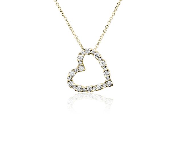 Love shimmers beautifully from this heart-shaped pendant hanging at a gracefully tilted angle. It features gleaming 14k yellow gold design that is beautifully set with shimmering diamonds for an eye-catching effect.