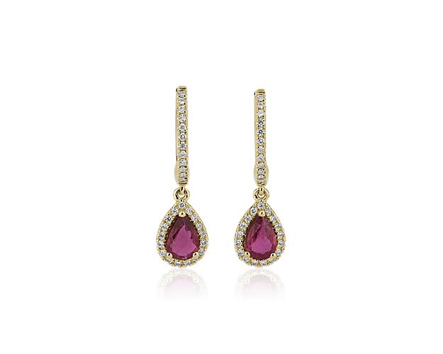 Pear-cut rubies dangle elegantly from these stunning drop earrings, showcasing dramatic red hues. Shimmering accent diamonds add eye-catching sparkle to the luxurious yellow gold design.