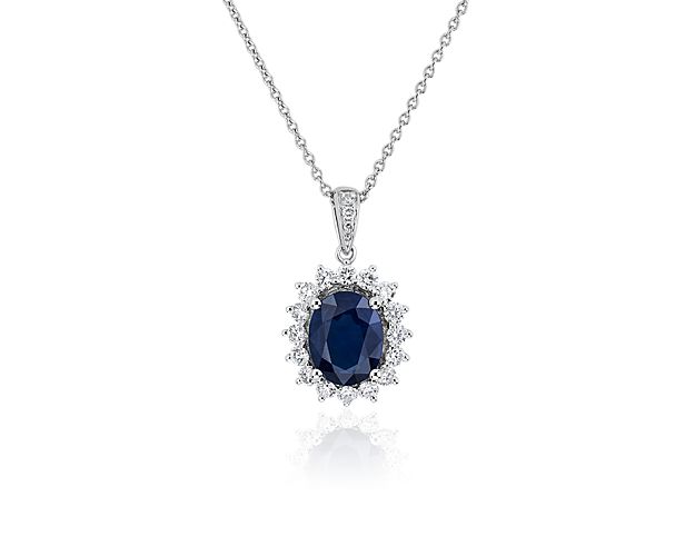 A dreamy blue sapphire sits at the heart of this elegant pendant, with a starburst halo of diamonds adding dramatic sparkle. The pendant and chain are made of gleaming white gold.