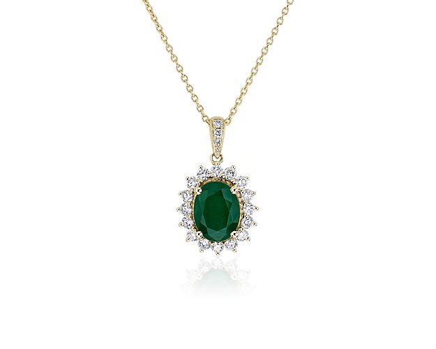 Opt for timelessly luxurious style with this pendant set with a vivid green emerald surrounded by a shimmering diamond starburst halo. The pendant and chain are crafted from lustrous yellow gold.