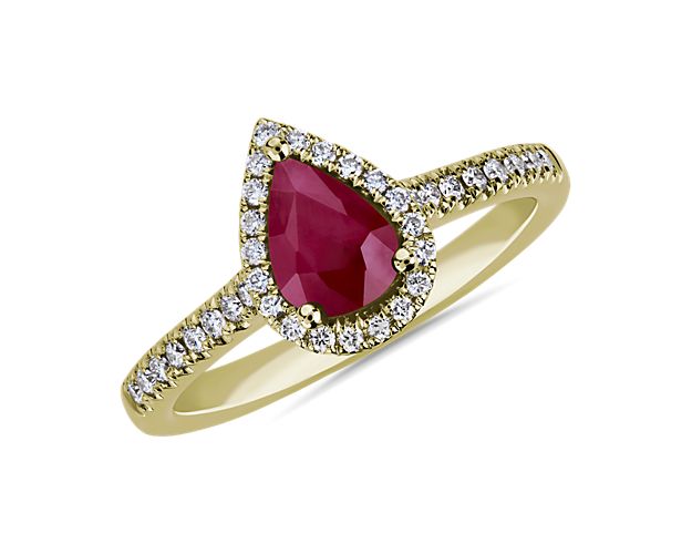 Pear shaped red ruby ring with accent diamonds in yellow gold