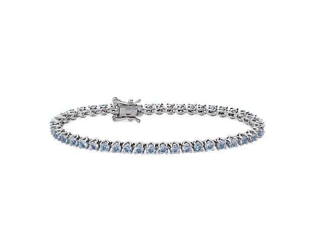 Complete your look with this classic tennis bracelet set with sky blue topaz stones that give it vivid color and sparkle. It is artfully crafted from gleaming sterling silver, and promises lasting quality.