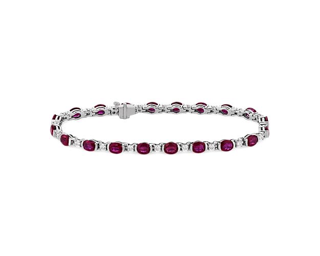 Elevate your style with this eye-catching bracelet crafted from gleaming white gold. Dramatic red rubies in a partial bezel setting alternate beautifully with sparkling diamonds for a dramatic effect.