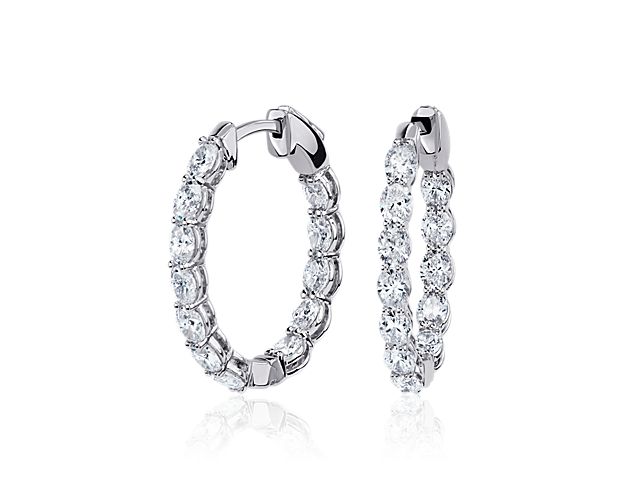 Lend a luxurious finish to your look with these eternity hoop earrings that sparkle with oval-cut diamonds set in the front-facing edges for a never-ending look. The 14k white gold design complements the stones with a bright gleam. Diameter of hoop measures 7/8 Inch.