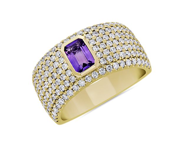 A bold emerald-cut purple amethyst sparkles at the heart of this ring, surrounded by beautifully delicate pavé-set diamonds. The wide 14k yellow gold design promises lasting lustre and quality.