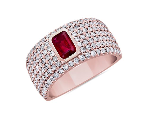 A bold emerald-cut deep red ruby sparkles at the heart of this ring, surrounded by beautifully delicate pavé-set diamonds. The wide 14k rose gold design promises lasting lustre and quality.