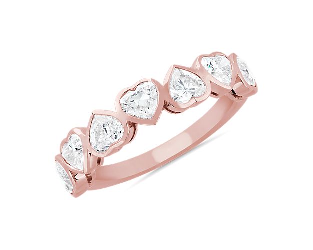 Mesmerize the eye with this stunning anniversary band featuring seven heart-cut diamonds that bring vintage-inspired art-deco charm. The beautiful bevel setting is crafted from 14k rose gold that promises a romantic bright gleam.