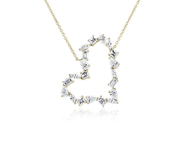 Add sparkle and love to your style with this heart-shaped pendant accented by beautifully sparkling diamonds in an eye-catching array of cuts. The 14k yellow gold design is delicately shaped and features a rich lustre.