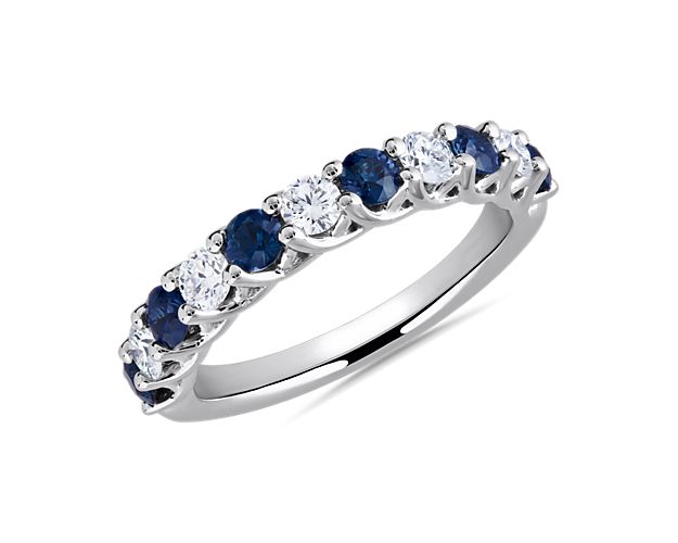 When you're looking for something a little different, deep toned blue sapphires and round-cut diamonds nestle together along this 14k white gold anniversary band.
