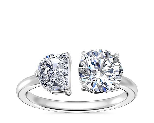 This unique engagement ring features a half-moon diamond and your chosen round, princess, pear, asscher, emerald-cut, radiant, cushion, marquise, or oval stone sparkling beautifully together. The 14k white gold design beautifully complement the stones with its soft luster.