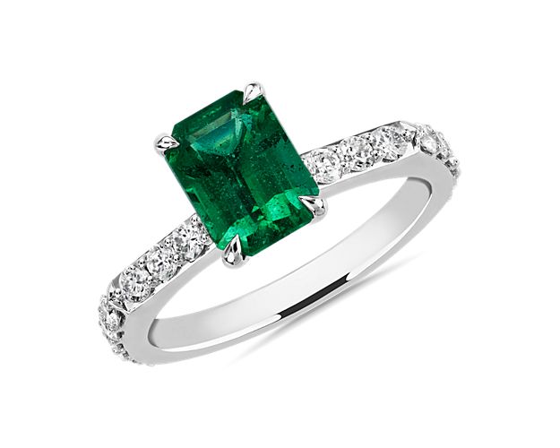 This beautiful ring set in 18k white gold features an emerald center stone with sparkling diamonds cascading along the band.  This ring is perfect for your next big night out.