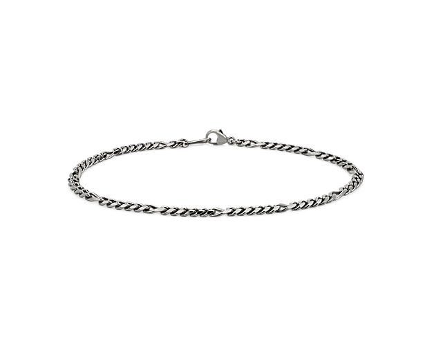 This platinum Figaro bracelet designed with square trios of links connected by longer rectangular links that alternate to create a balanced look made for everyday wear.