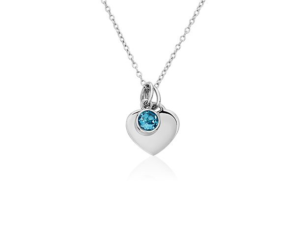 A shimmering, bezel-set blue topaz comes paired with a polished silver heart in this pretty pendant. The delicate charms are strung on a classic cable chain that can fasten at either 16 or 18 inches, making it a perfect layering piece.