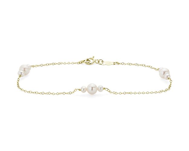Three luminous trios of pearls sit suspended on the lighter-than-air chain of this 14k yellow gold bracelet for a look that gives a nod to vintage glamour with a thoroughly modern silhouette.