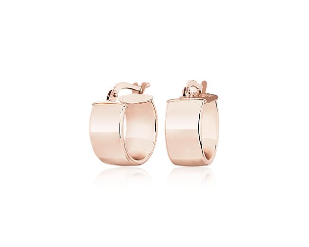 An instantly iconic addition to your ear stack, these lobe-hugging 14k rose gold hoops are designed with a sleek low profile curve that leaves a bold impression on its own or effortlessly paired with your go-to studs.