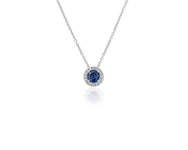 Capture your ray of starlight when layering on this striking 14k white gold pendant necklace. Its perfectly round sapphire baths in the light of a white diamond halo creating a beautiful interplay of sparkle and color.