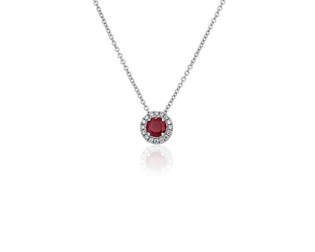 Capture your ray of starlight when layering on this striking 14k white gold pendant necklace. Its perfectly round ruby baths in the light of a white diamond halo creating a beautiful interplay of sparkle and color.