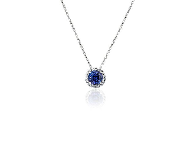 Capture your ray of starlight when layering on this striking 14k white gold pendant necklace. Its perfectly round tanzanite baths in the light of a white diamond halo creating a beautiful interplay of sparkle and color.