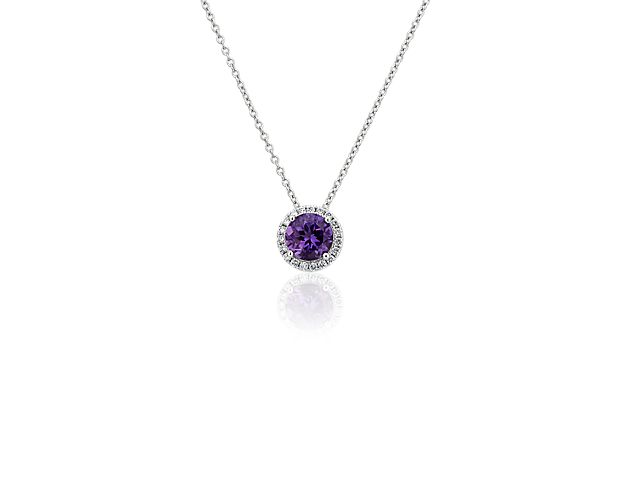 Capture your ray of starlight when layering on this striking 14k white gold pendant necklace. Its perfectly round amethyst baths in the light of a white diamond halo creating a beautiful interplay of sparkle and color.