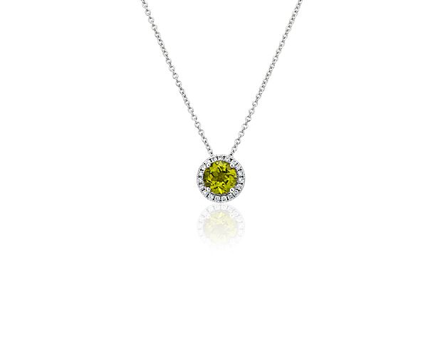Capture your ray of starlight when layering on this striking 14k white gold pendant necklace. Its perfectly round peridot baths in the light of a white diamond halo creating a beautiful interplay of sparkle and color.