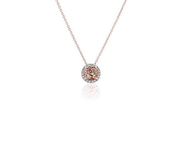 Capture your ray of starlight when layering on this striking 14k rose gold pendant necklace. Its perfectly round morganite stone baths in the light of a white diamond halo creating a beautiful interplay of sparkle and color.