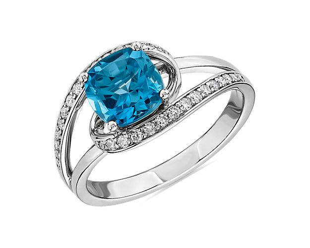 A twist of brilliance and a touch of blue will give an elegant sparkle to your look. Entwined rows of shimmering diamonds add grace to this stunning ring crafted in 14k white gold.