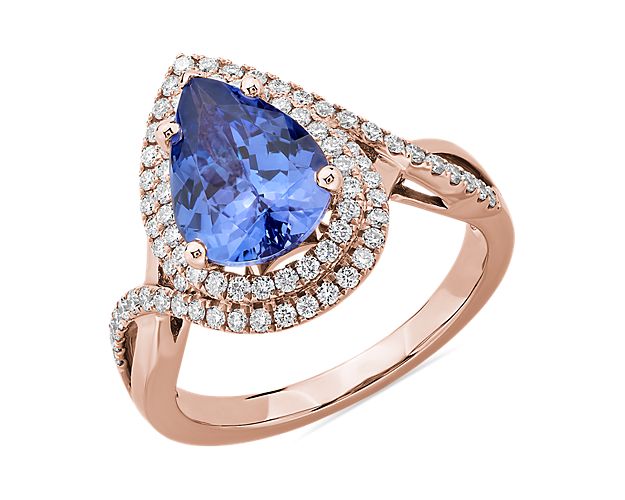 Truly a statement piece, this 14k rose gold ring displays significant color from its pear-shaped tanzanite center stone, and the diamond halos surrounding it. The pave-set diamond band provides remarkable brilliance.