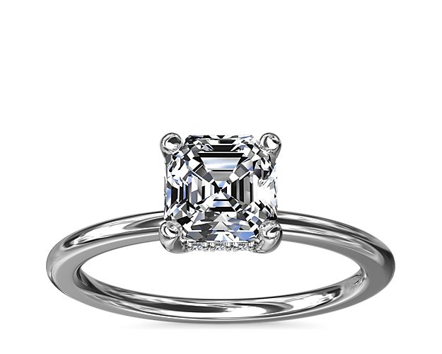 A reflection of love made to last a lifetime, this 14k white gold engagement ring is flawlessly designed with an elegant, thin shank uplifting a single center stone and a hidden halo of diamonds nestled underneath.