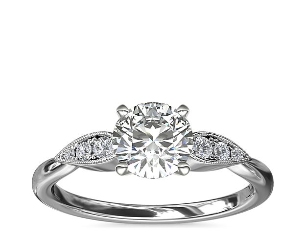 Celebrate love with extra sparkle. This beautiful design in 14k white gold features delicate pear-shaped details set with three petite diamonds flanking each side of your center stone.