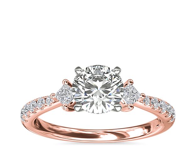 Celebrate sparkle with a romantic design. This beautiful style features two east-west princess-cut diamond sidestones and 10 round pavé-set diamonds flanking the center stone of your choice set in 14k rose gold.