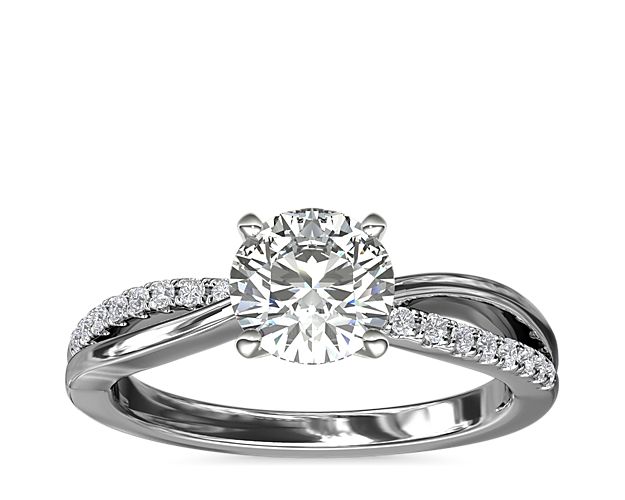 A symbol of love eternal, 14k white gold is transformed into an elegant foundation for this diamond engagement ring accented with sparkling pavé diamonds set into its infinity-shaped band.