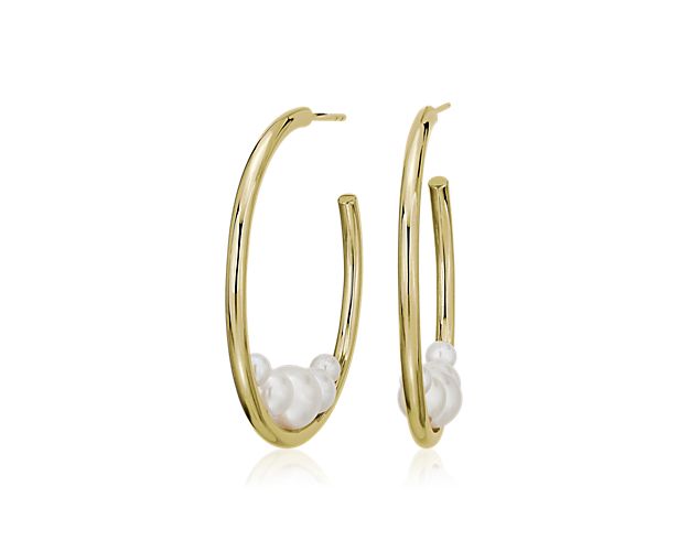 Give your everyday look a touch of timeless style with 14k yellow gold hoops designed with five graduated freshwater pearls nestled together at the bottom of their floating silhouette.